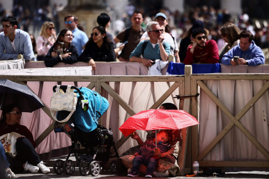 El público espera bajo el sol la nueva votación del cónclave