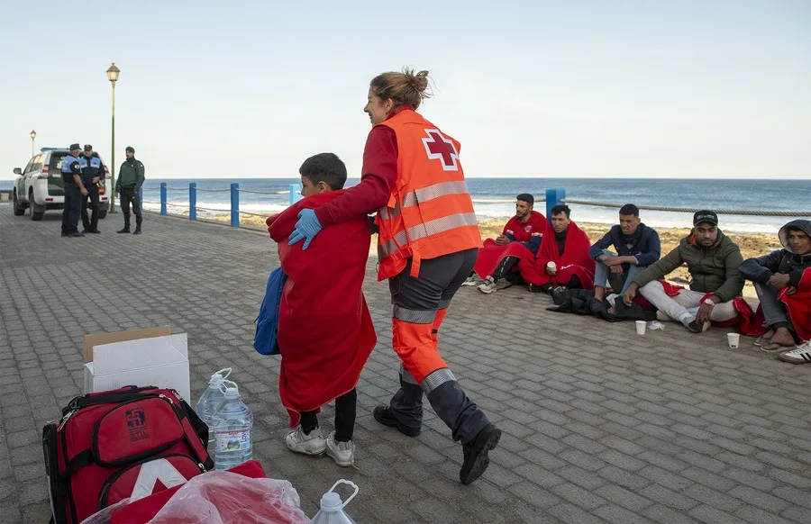 Una voluntaria de Cruz Roja asiste a un menor llegado en una patera a Lanzarote, en una imagen de archivo. EFE/Adriel Perdomo