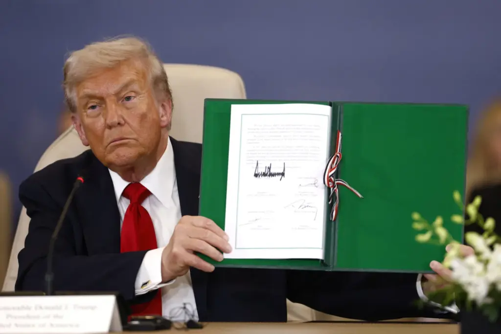 El presidente de Estados Unidos, Donald Trump, posa con el acuerdo firmado en una cumbre de líderes mundiales para poner fin a la guerra de Gaza, en medio de un intercambio de prisioneros y rehenes negociado por Estados Unidos y un acuerdo de alto el fuego entre Israel y Hamás, en Sharm el-Sheikh, Egipto, el 13 de octubre de 2025. Yoan Valat/REUTERS