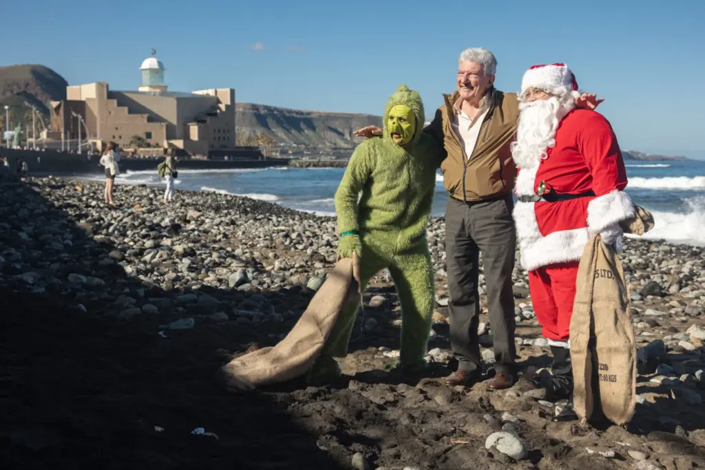 El Grinch y Papá Noel reivindican en la playa de Las Canteras una Navidad más verde