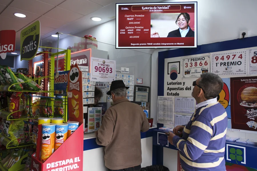 LA VICTORIA DE ACENTEJO (TENERIFE) (ESPAÑA), 22/12/2025.- Dos hombres compran lotería este lunes en el estanco El Chazo, en el municipio tinerfeño de La Victoria de Acentejo, donde hoy ha caído un tercer premio de la lotería de navidad. EFE/Alberto Valdés