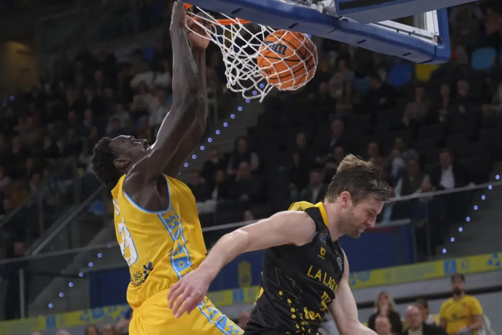 El pivot estadounidense de Gran Canaria Kur Kuath (i) machaca la canasta ante el jugador de la Laguna Tenerife 