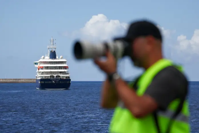 Un miembro de los medios de comunicación trabaja cerca del crucero MV Hondius, afectado por un brote de hantavirus, en el puerto de Granadilla de Abona, Tenerife, España, el 11 de mayo de 2026. REUTERS/Pedro Nunes