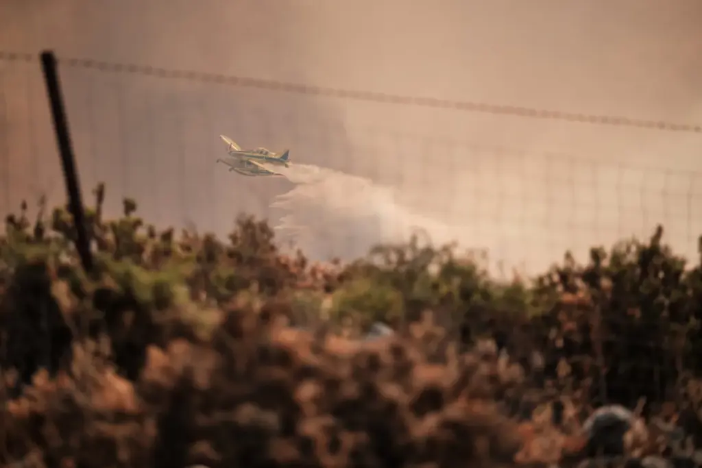 La Junta de Andalucía ha activado esta madrugada la fase de emergencia, en situación operativa 1, ante la evolución del incendio forestal declarado en el término municipal de Igualeja (Málaga), donde se ha decretado el confinamiento de la población y se ha cortado al tráfico la carretera MA-7304. En la imagen, aeronaves del servicio de Bomberos trabajan en la extinción del incendio. EFE/Gregorio Marrero