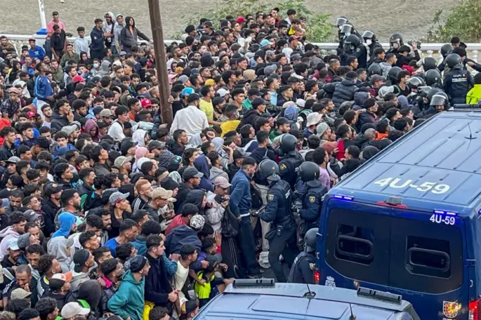 Traslado de migrantes asentados en la playa de Benítez, este viernes. Las autoridades han iniciado a primera hora de este viernes el traslado de los migrantes asentados en las playas de Benítez y el Trampolín de Ceuta hasta el campamento temporal habilitado en el puerto de la ciudad, con capacidad para unas 1.700 personas. Un amplio dispositivo policial se ha desplegado en torno a las 7:15 de la mañana en ambos asentamientos, donde permanecen adultos y menores desde la entrada masiva registrada el pasado 30 de julio. EFE/Reduan